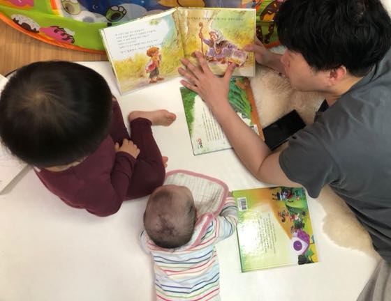 A baby spending time with parents during the day