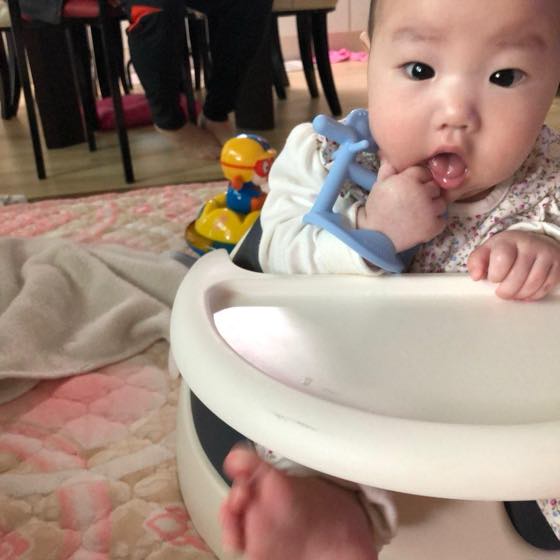 A baby chewing on a cold teether