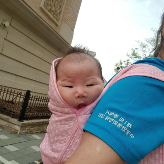 A parent holding a baby and getting ready for a doctor's visit