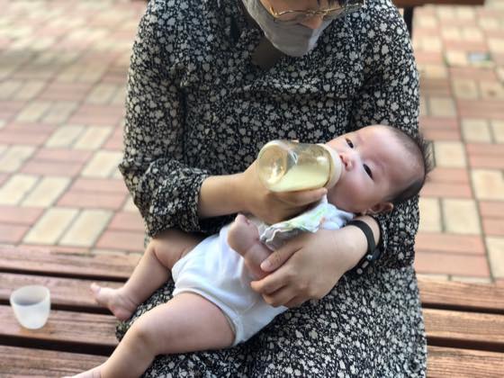 A baby drinking formula from a bottle